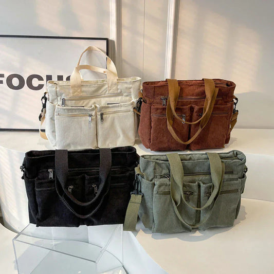 Urban Cord Tote in olijfgroen en zwart, gemaakt van zacht corduroy met meerdere vakken en veelzijdige draagopties – perfect voor dagelijks gebruik.